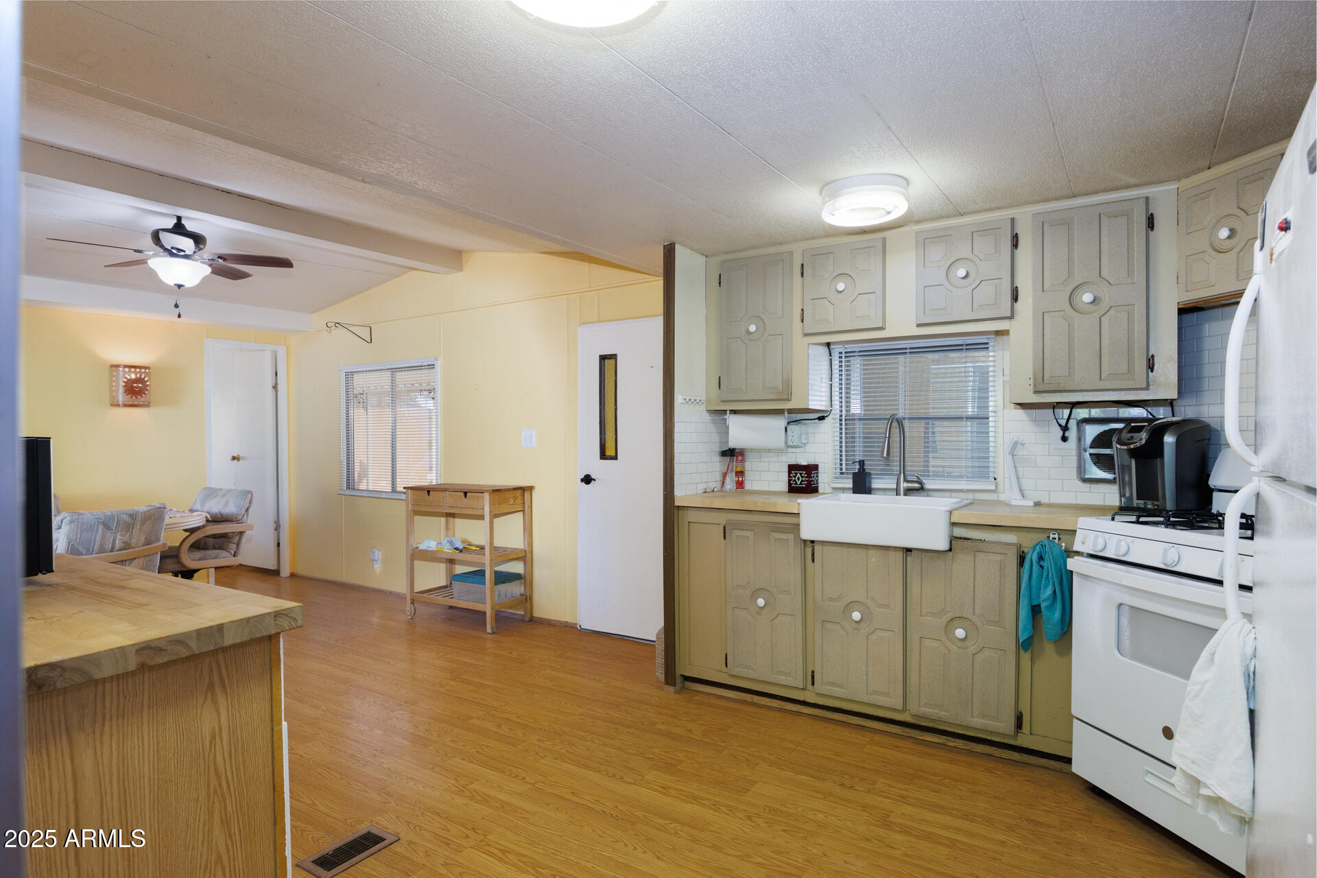 2100 North Trekell Road, Unit 351 Casa Grande, AZ 85122 - Photo 12 of 31 a kitchen with a sink cabinets and wooden floor