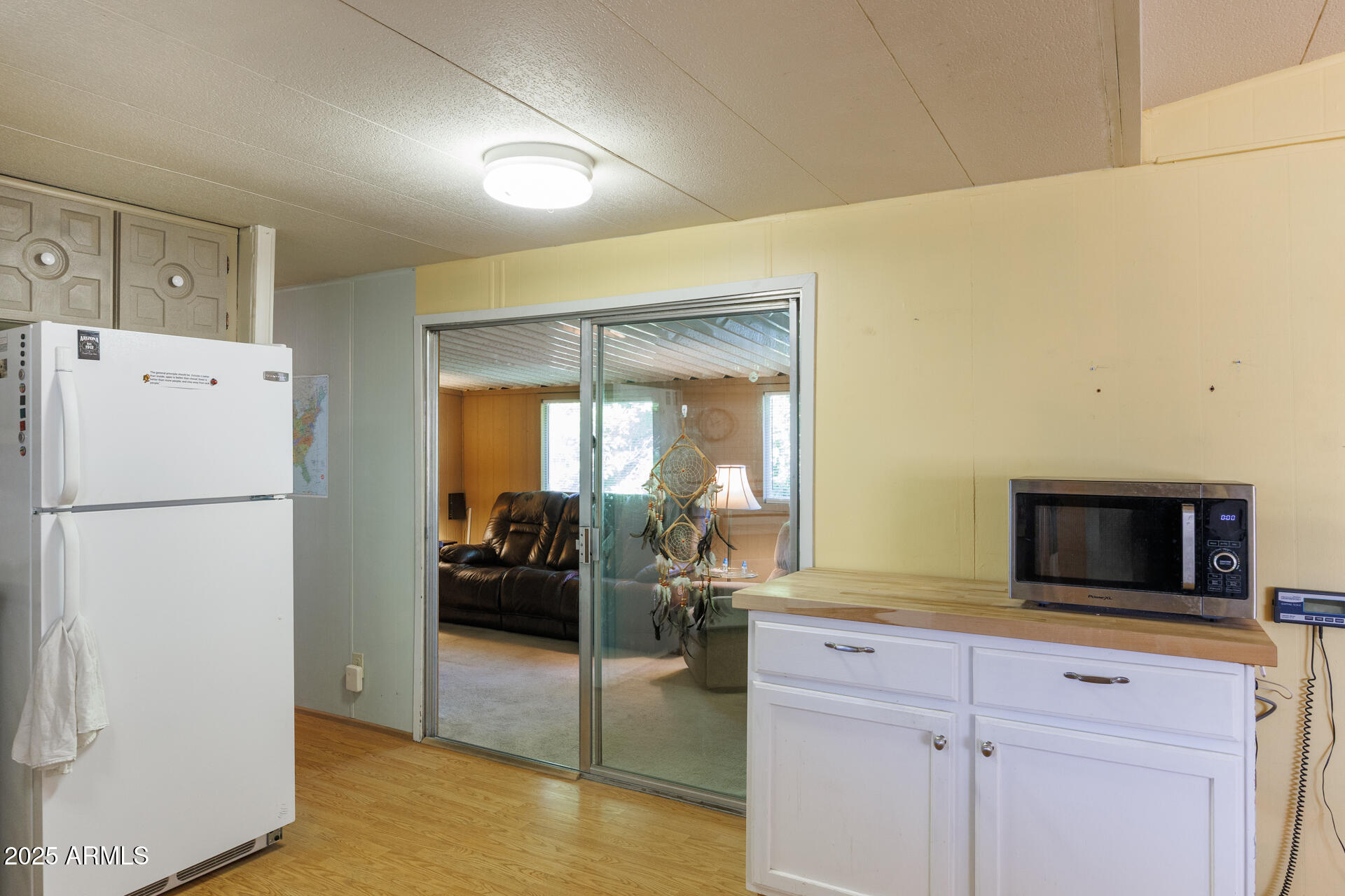 2100 North Trekell Road, Unit 351 Casa Grande, AZ 85122 - Photo 16 of 31 a kitchen with a refrigerator and cabinets