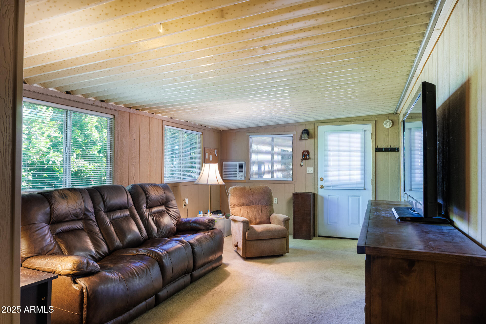 2100 North Trekell Road, Unit 351 Casa Grande, AZ 85122 - Photo 8 of 31 a living room with furniture a window and a flat screen tv