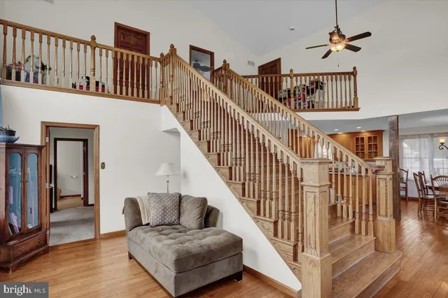 a living room with fireplace furniture and a wooden floor