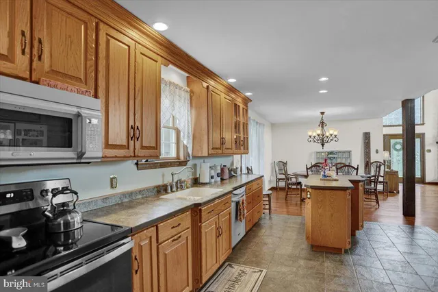 a kitchen with stainless steel appliances granite countertop a sink and cabinets