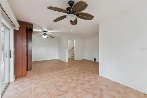 a view of empty room with ceiling fan