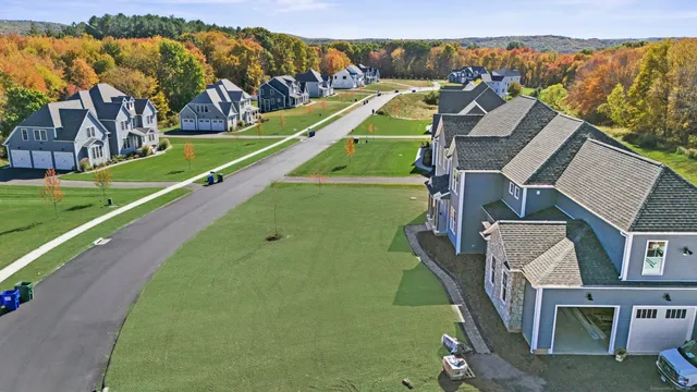 an aerial view of a house with a big yard