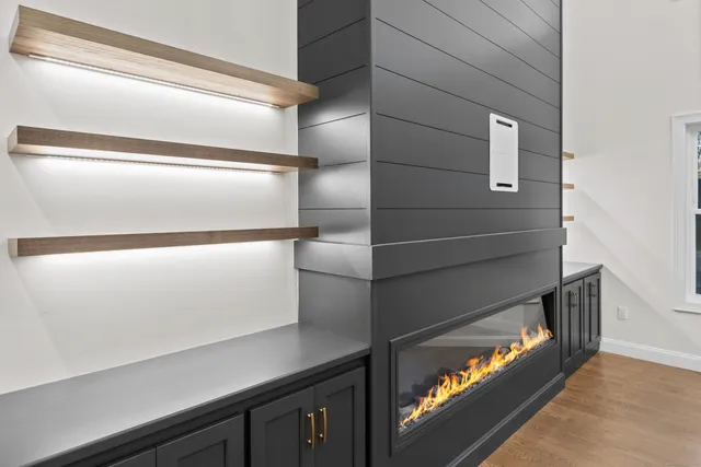 a view of cabinets a sink and a stove in a room