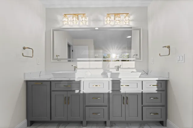 a bathroom with a sink vanity and mirror