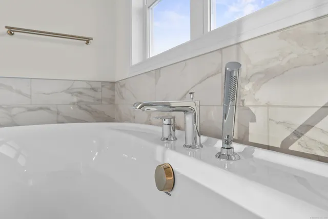 a bathroom with a shower and a mirror