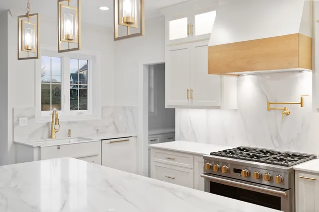 a kitchen with a sink and a stove top oven