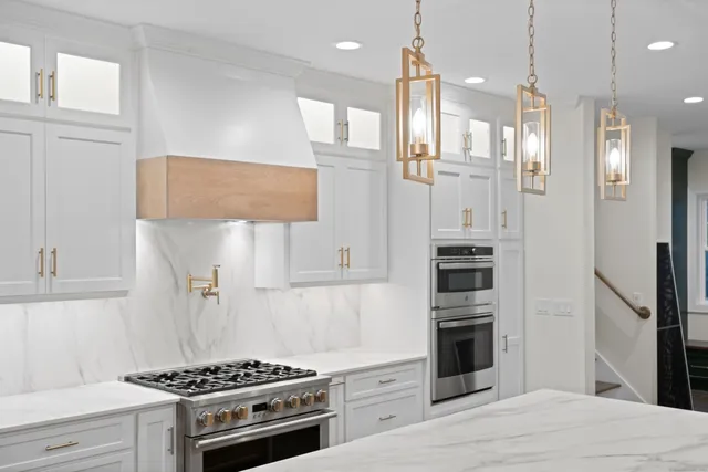 a large kitchen with kitchen island a sink stainless steel appliances and cabinets