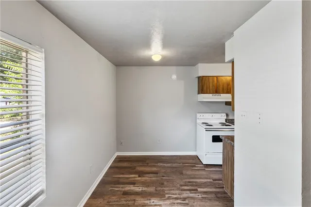 a view of a livingroom with wooden floor and a flat screen tv