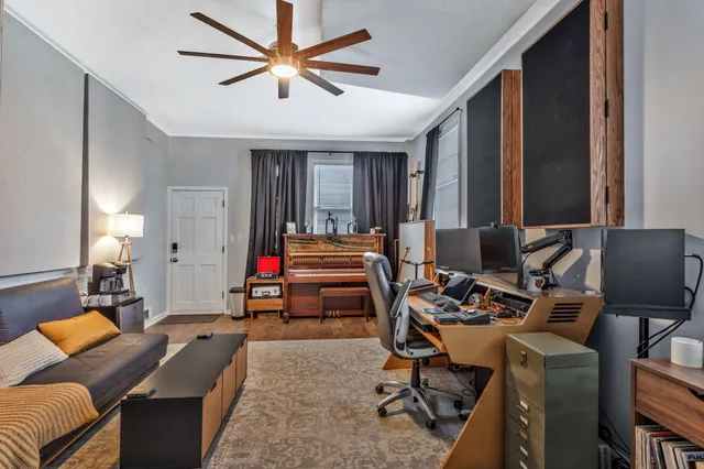 a room with furniture and a ceiling fan