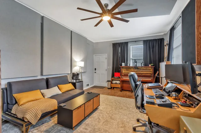 a living room with furniture and a chandelier