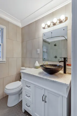 a bathroom with a toilet a sink and mirror
