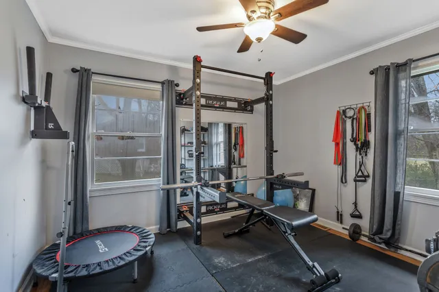 a living room with furniture a ceiling fan and a window
