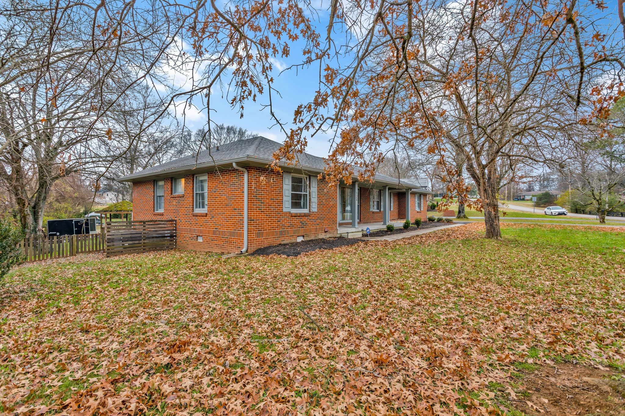 124 North Laurel Circle Columbia, TN 38401 - Photo 3 of 40 a backyard of a house with large trees and outdoor seating