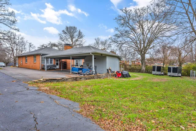 a view of a house with swimming pool and a yard