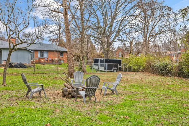 a swimming pool with table and chairs