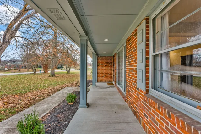 a view of a porch with wooden floor and fence