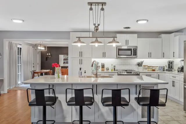 a kitchen with cabinets a sink and appliances