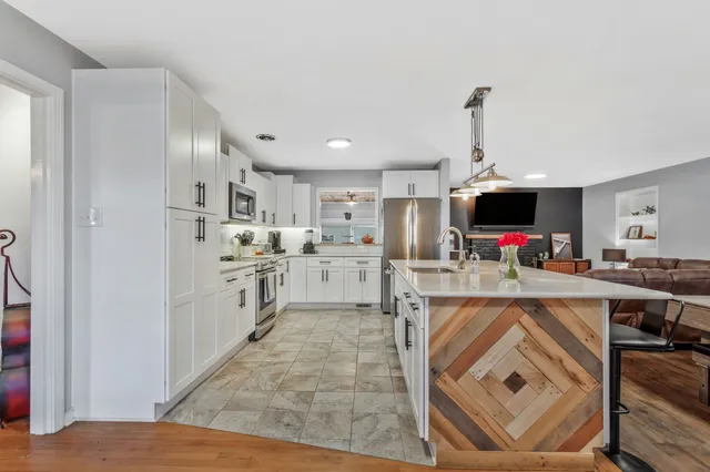 a view of kitchen with sink microwave and refrigerator