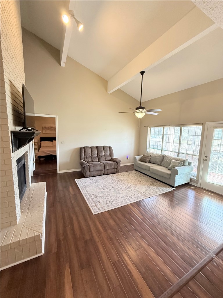 76 Club Road Dover, AR 72837 - Photo 10 of 36 Living room featuring a ceiling fan, a brick fireplace, dark wood-style flooring, and vaulted ceiling