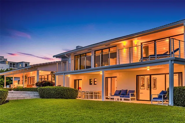 a view of a patio with a table and chairs and potted plants