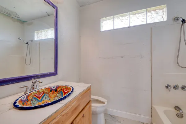 a bathroom with a sink toilet and shower