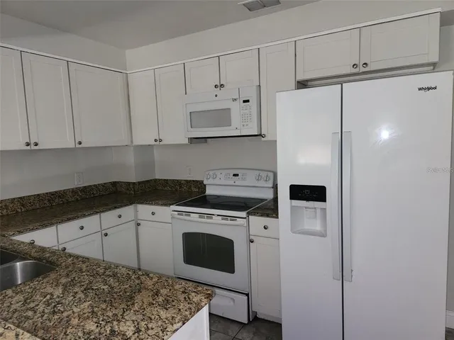 a kitchen with a stove a sink and a refrigerator