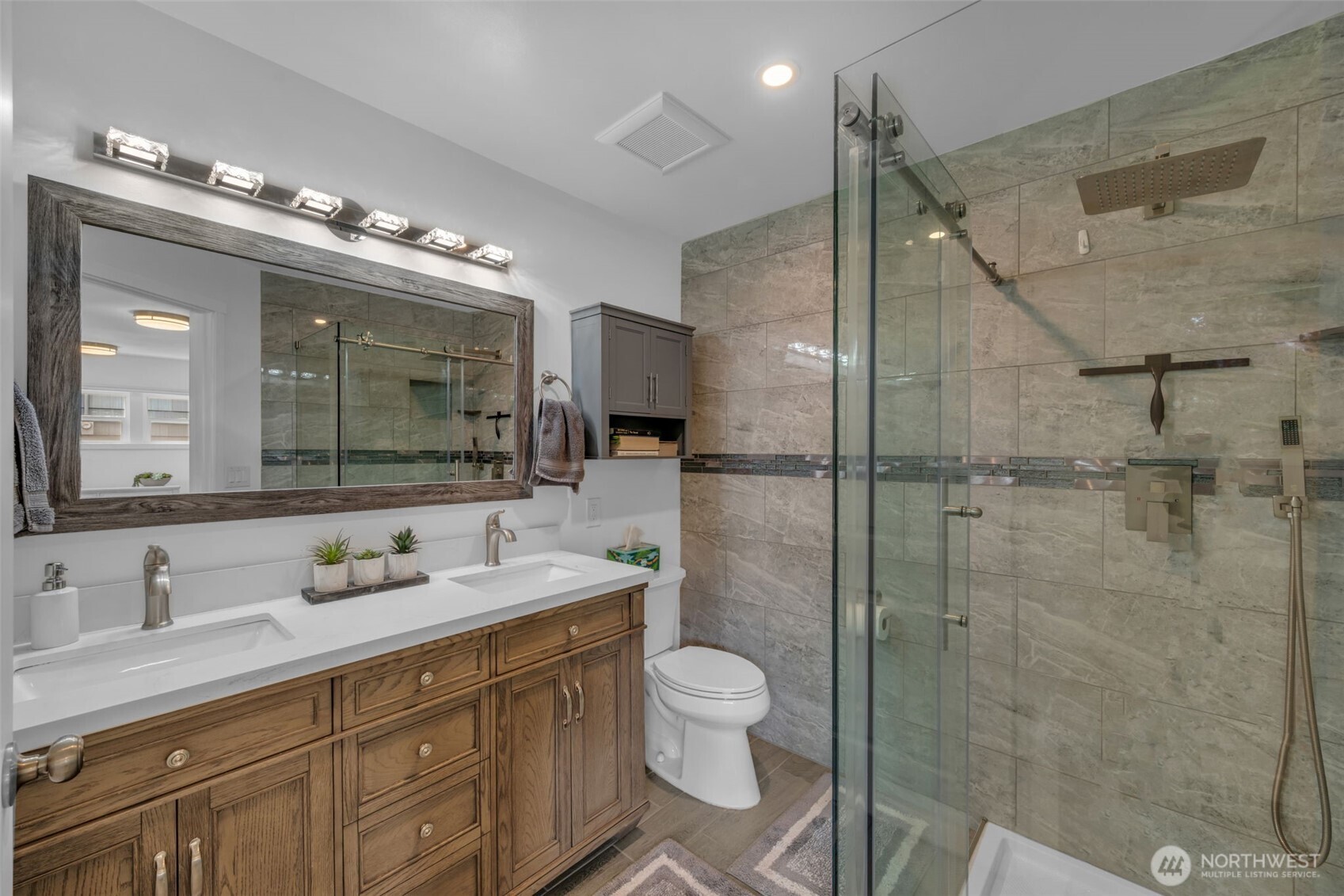 9015 218th Street Southwest Edmonds, WA 98026 - Photo 25 of 39 a bathroom with a double vanity sink toilet and shower
