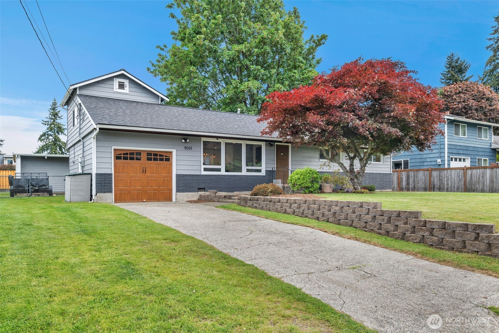 9015 218th Street Southwest Edmonds, WA 98026 - Photo 5 of 39 a front view of a house with a yard and garage