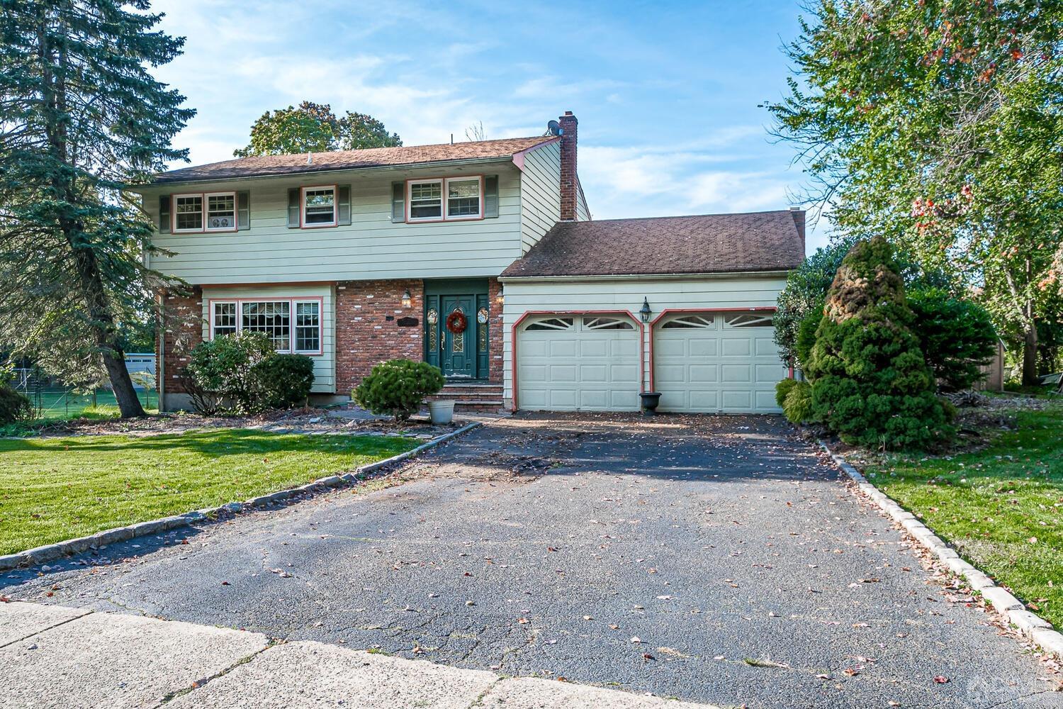 a front view of a house with a yard and a garage