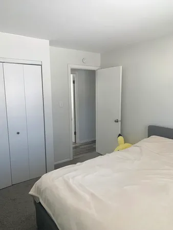 a bedroom with a bed and a shower