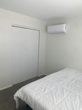 a bedroom with a bed and a shower