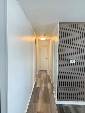 a view of a room with wooden floor