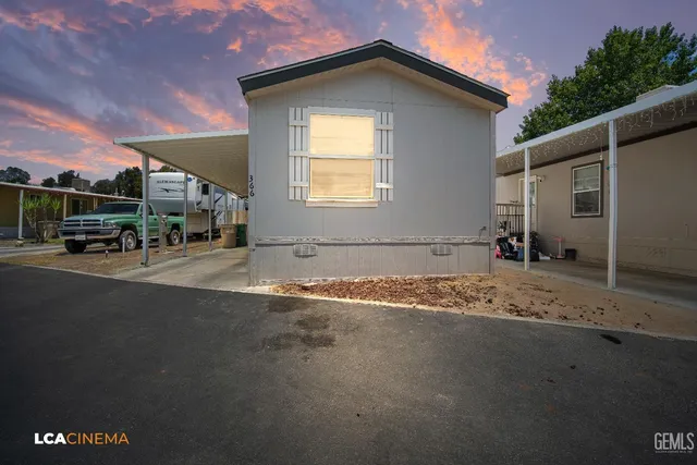 a backyard of a house with table and chairs