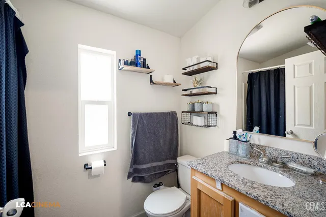 a bedroom with a bed and flat screen tv