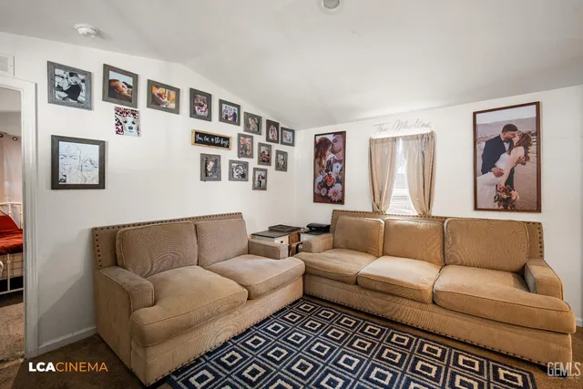 a kitchen with granite countertop a refrigerator stove top oven and sink