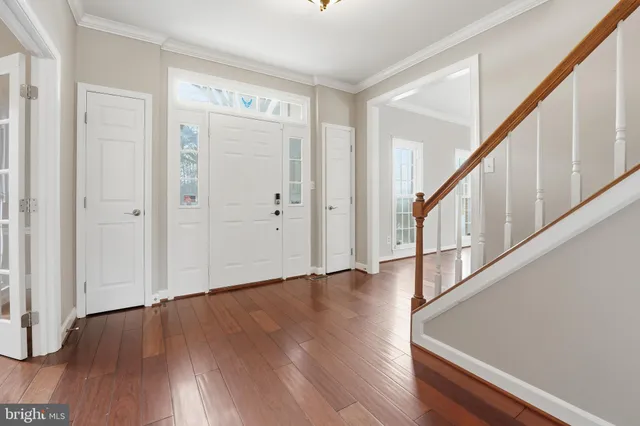 a view of empty room with wooden floor and fireplace