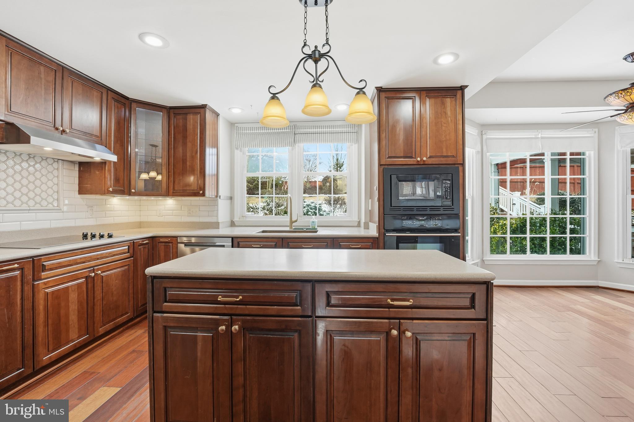 3582 Lions Field Road Triangle, VA 22172 - Photo 20 of 66 a kitchen with a stove a sink and a wooden cabinets