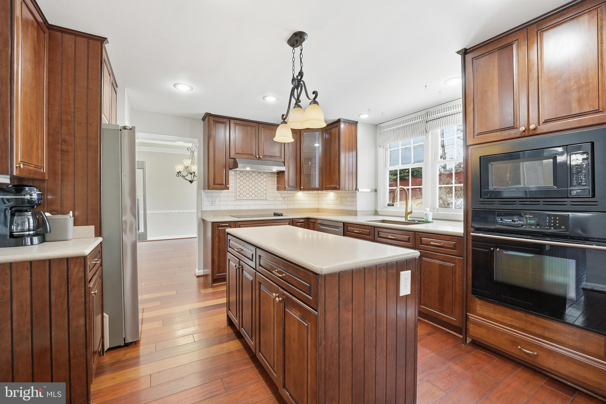 3582 Lions Field Road Triangle, VA 22172 - Photo 21 of 66 a kitchen with stainless steel appliances granite countertop a kitchen island a stove and a wooden floors