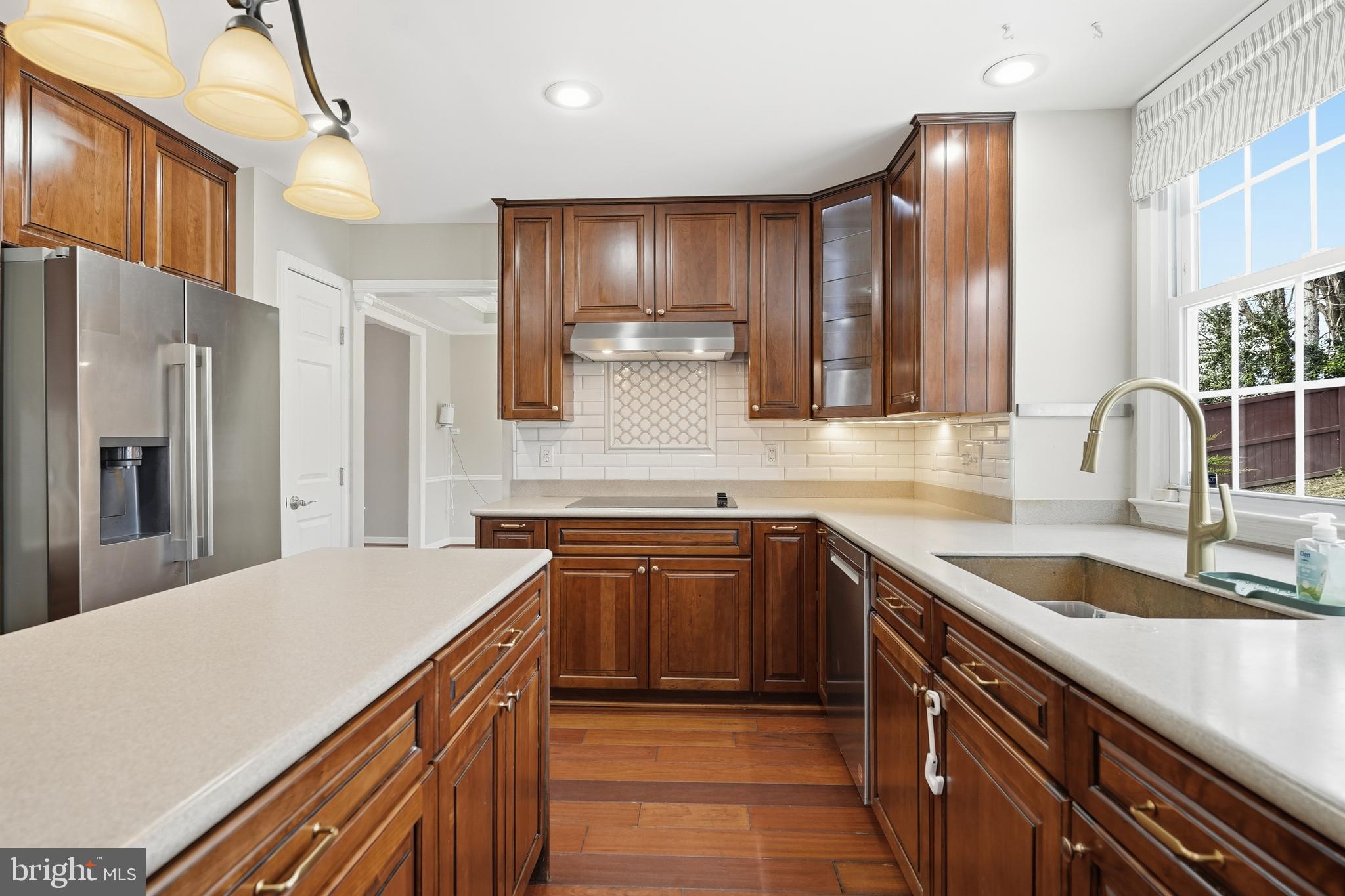 3582 Lions Field Road Triangle, VA 22172 - Photo 22 of 66 a kitchen with stainless steel appliances granite countertop a sink stove and refrigerator