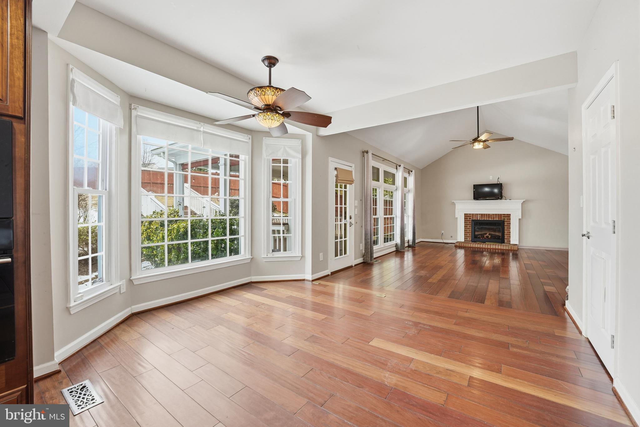 3582 Lions Field Road Triangle, VA 22172 - Photo 26 of 66 a view of an empty room with wooden floor fireplace and a window
