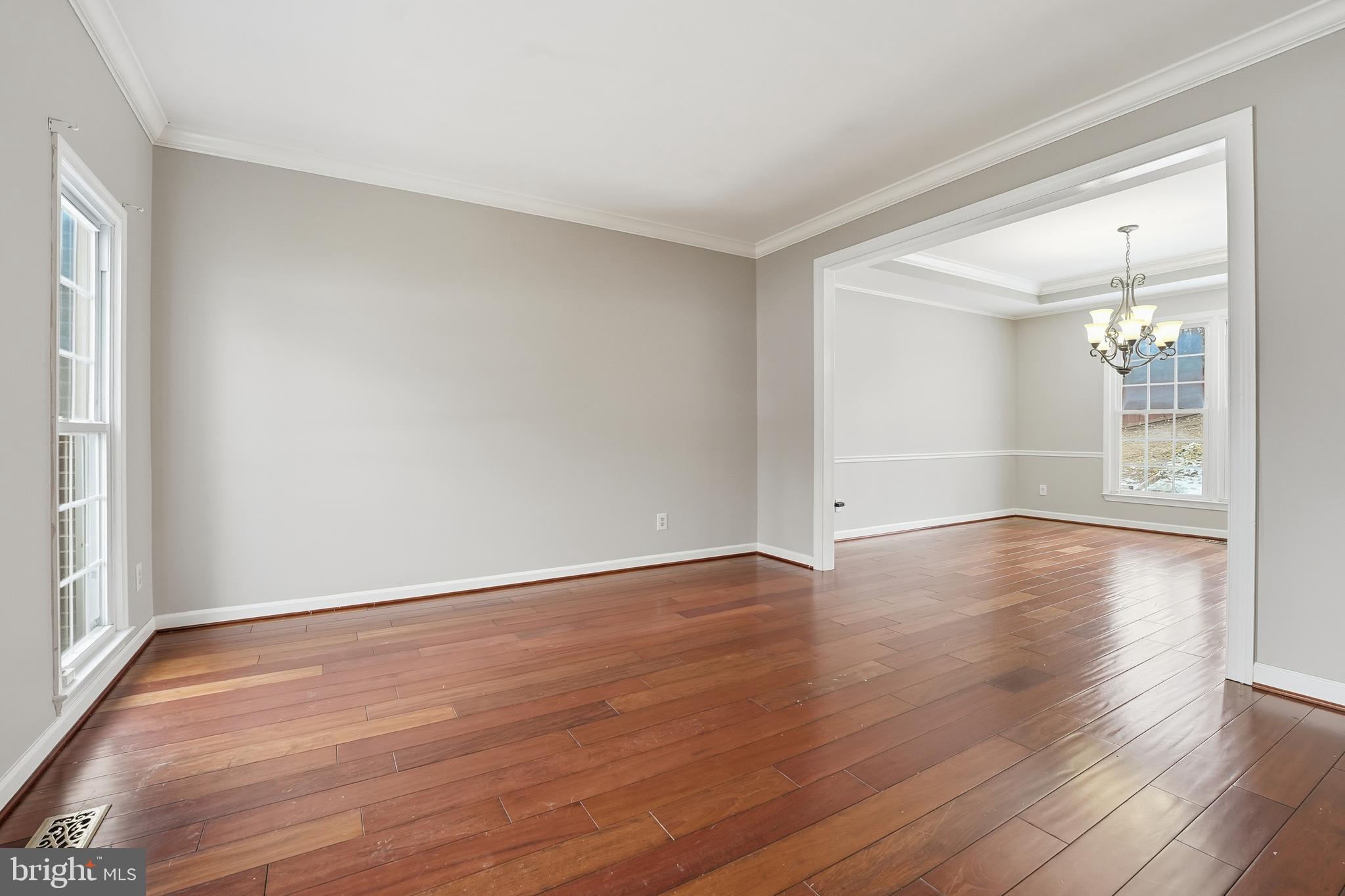 3582 Lions Field Road Triangle, VA 22172 - Photo 28 of 66 a view of an empty room with wooden floor and a window