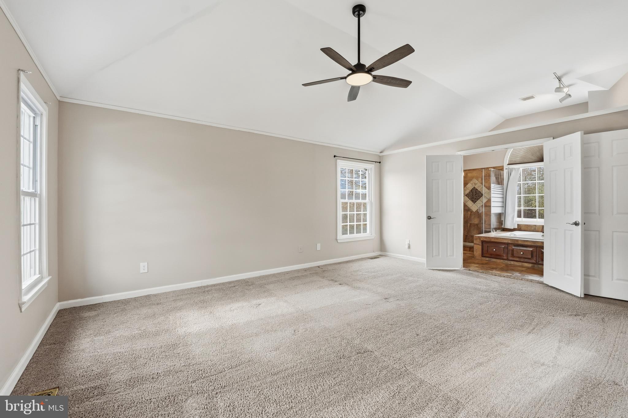 3582 Lions Field Road Triangle, VA 22172 - Photo 30 of 66 an empty room with chandelier fan and windows