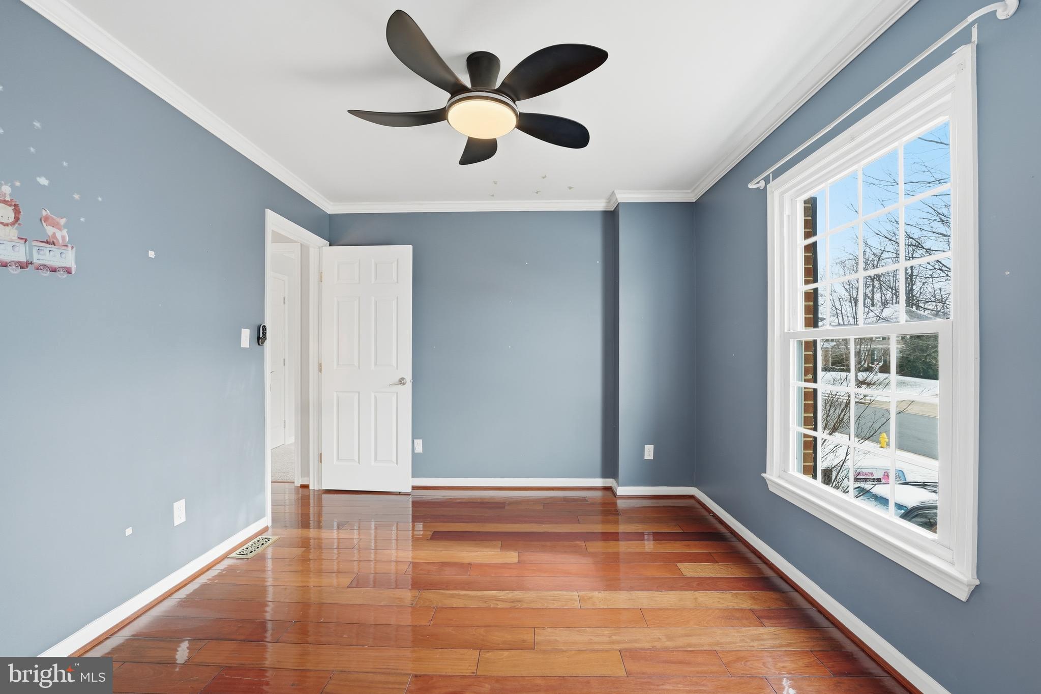 3582 Lions Field Road Triangle, VA 22172 - Photo 39 of 66 a view of an empty room with a window and wooden floor