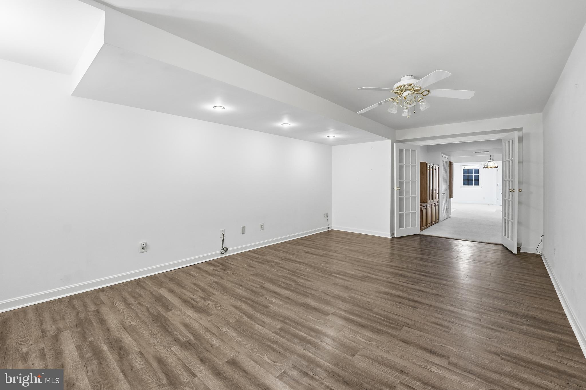 3582 Lions Field Road Triangle, VA 22172 - Photo 50 of 66 an empty room with wooden floor and ceiling fan