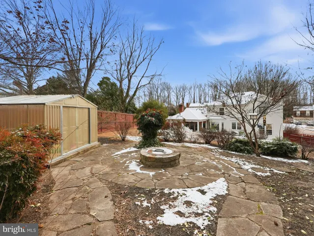 a kitchen with a stove a sink and a wooden cabinets