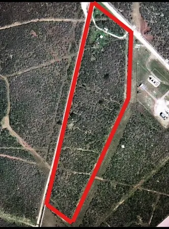 a view of a backyard with a small house and wooden deck