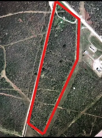 a view of a backyard with a small house and wooden deck