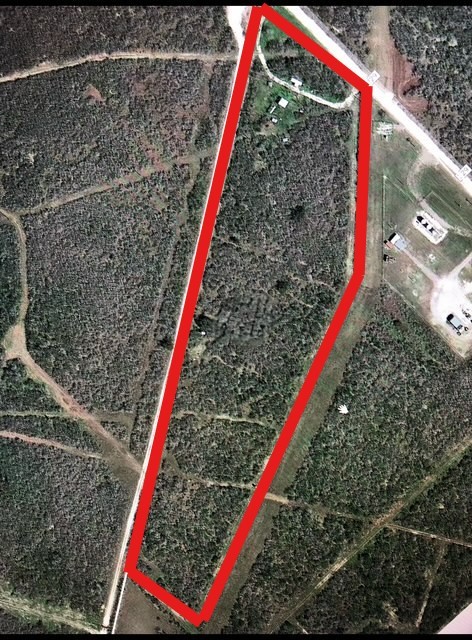 a view of a backyard with a small house and wooden deck