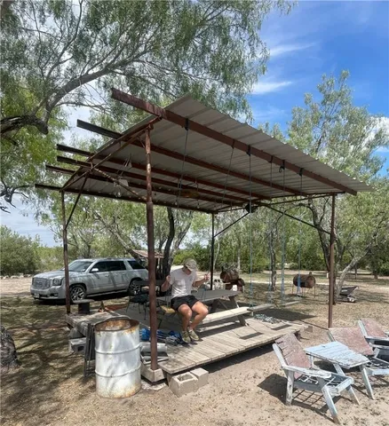 a view of backyard with outdoor seating and plants